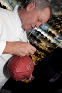 2011 Super Bowl - Wolfgang Puck Autographing a Football 